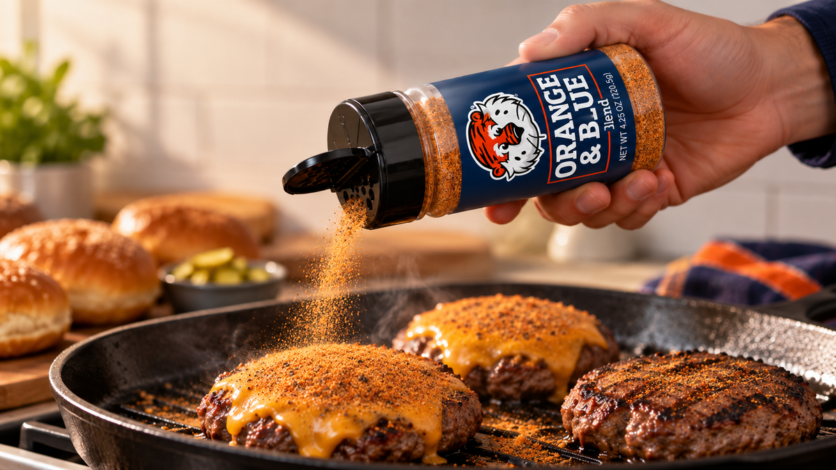 Orange and Blue Blend shaken onto cheeseburgers in a skillet